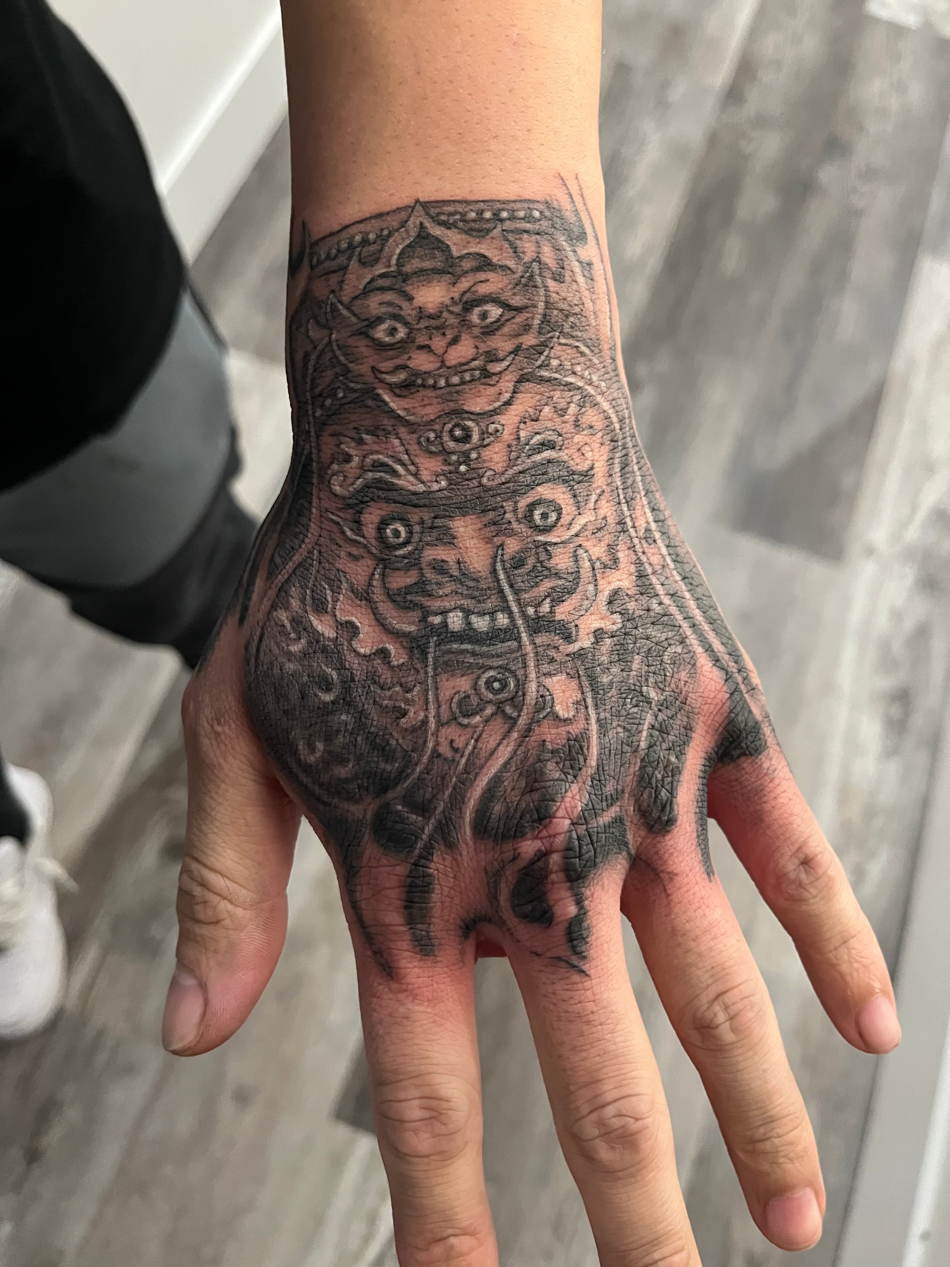 Foo dog hand tattoo black and grey Asian art by Tony Luong Maple Valley WA