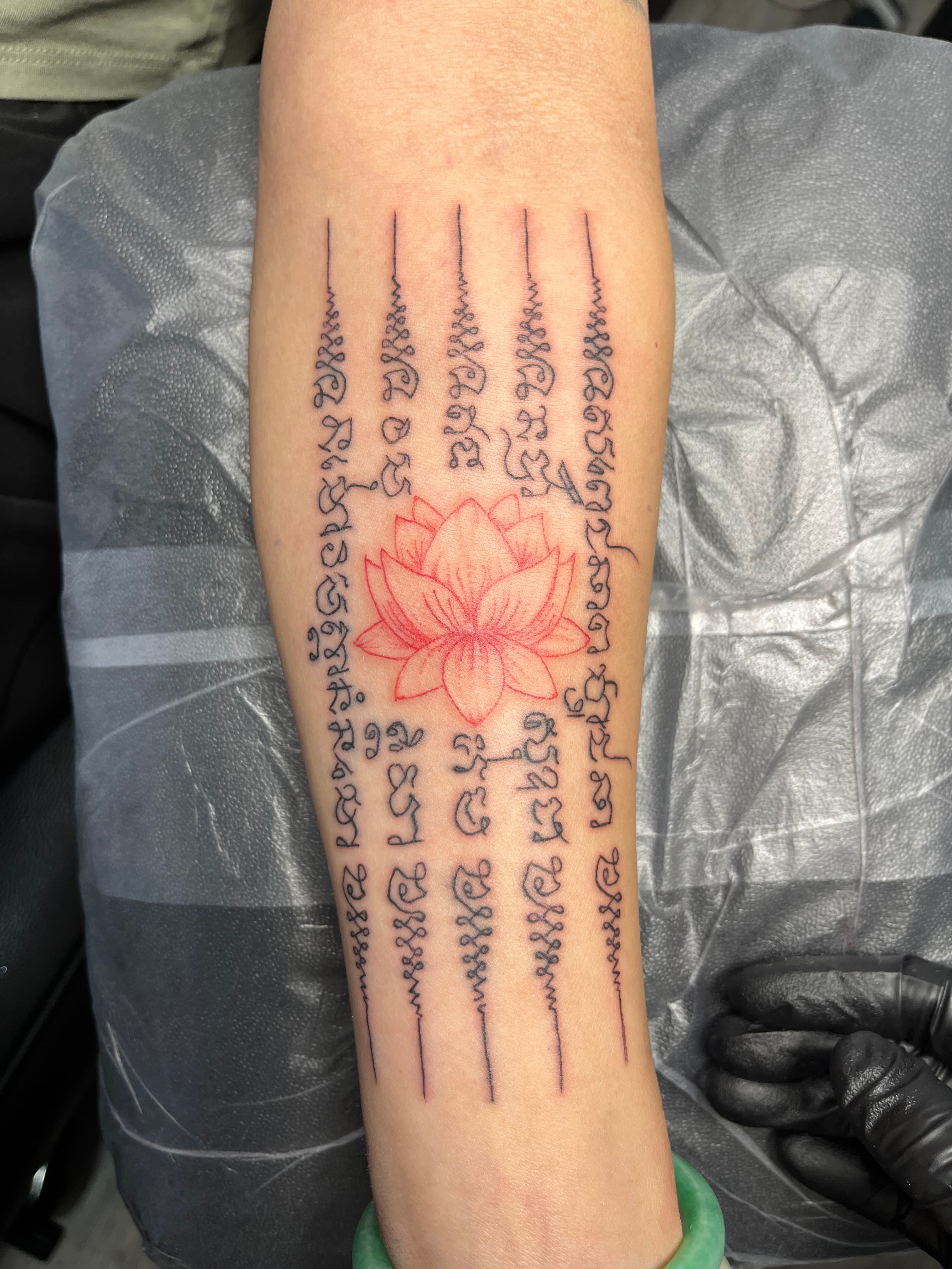 Sak Yant lotus flower fine line tattoo with sacred script by Tony Luong Maple Valley WA